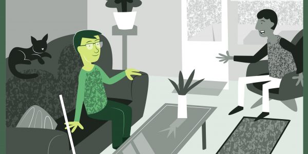 Bilden visar en person som sitter hemma i sin lägenhet och samtalar med en gäst. De verkar trivas i miljön Bilden visar en person som sitter hemma i sin lägenhet och samtalar med en gäst. De verkar trivas i miljön